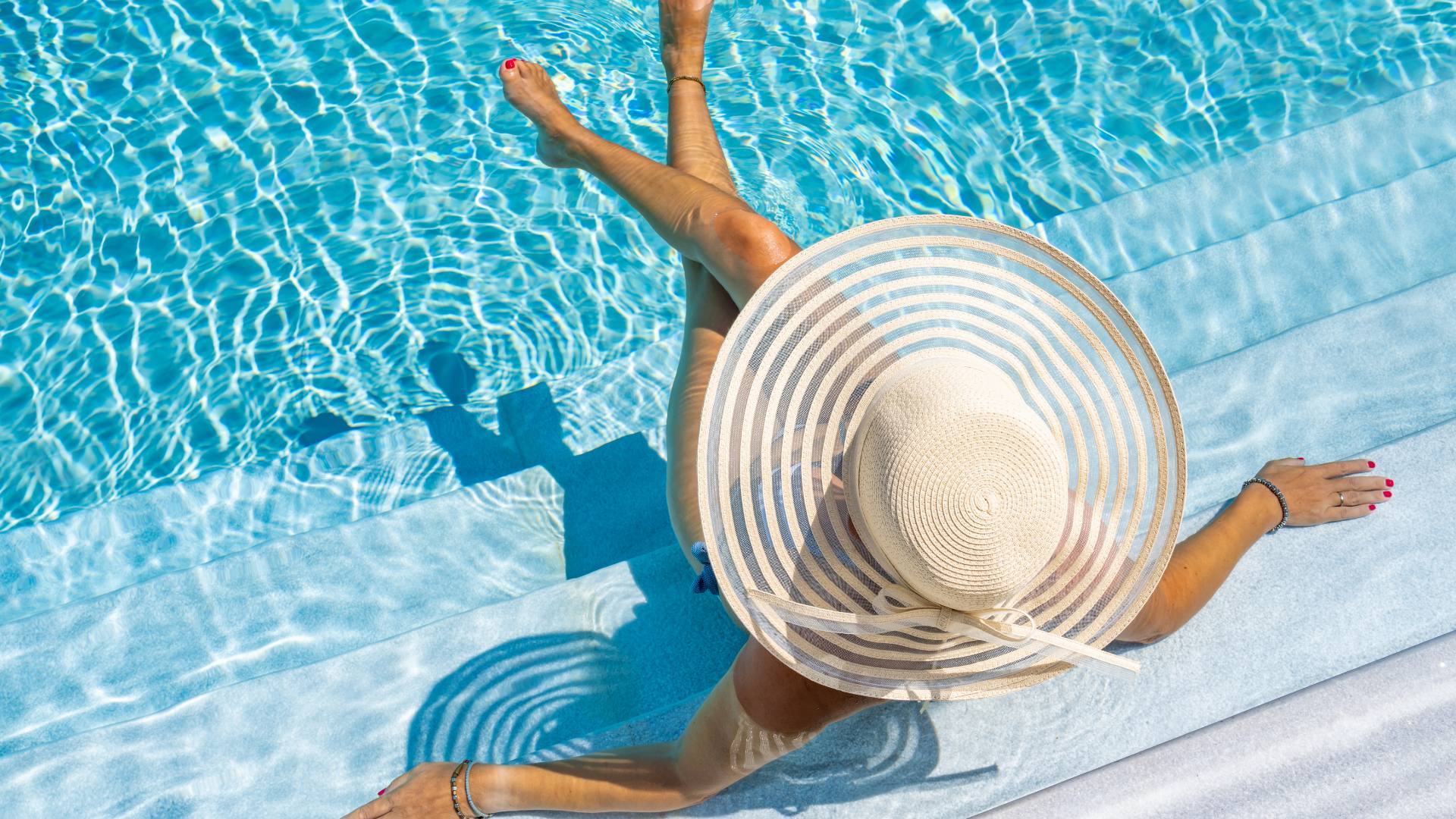 Homeowner relaxing beside a freshly relined vinyl pool